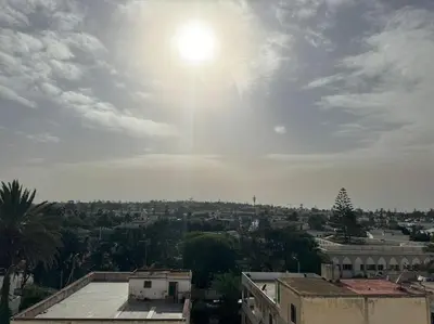 a view of a city with the sun in the sky at 47 Appartement luxueux proche de la mer in Casablanca