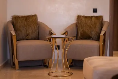 two chairs and a table in a room at Appartement Prestige et Confort in Casablanca