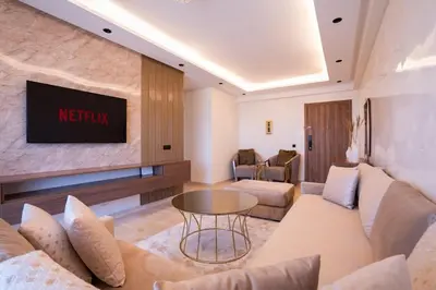 a living room with a television on a wall at Appartement Prestige et Confort in Casablanca
