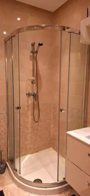 a shower with a glass door in a bathroom at Les Jardins De Bouznika GHA4 in Bouznika