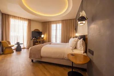 a bedroom with a large bed and a table at Le Square By Onomo Collection in Casablanca