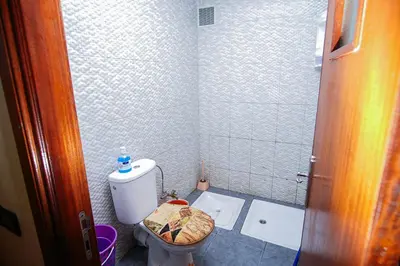 a small bathroom with a toilet and a sink at Peaceful Apartment with AC & fiber-speed internet in Casablanca