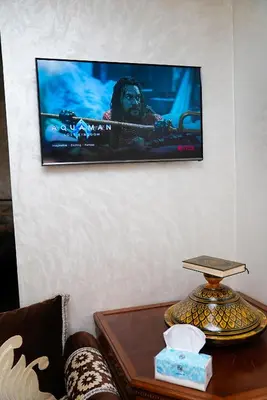 a flat screen tv hanging on a wall at Peaceful Apartment with AC & fiber-speed internet in Casablanca