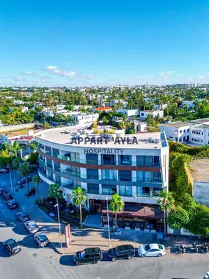 an aerial view of a hotel with cars parked in a parking lot at Bright Spacious Suite- By Appart'Ayla in Casablanca