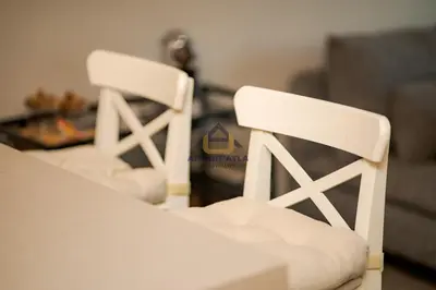 two white chairs sitting in a living room at Bright Spacious Suite- By Appart'Ayla in Casablanca