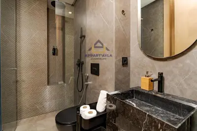 a bathroom with a sink and a toilet and a mirror at Bright Spacious Suite- By Appart'Ayla in Casablanca
