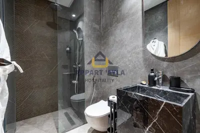 a bathroom with a toilet and a sink and a mirror at Bright Spacious Suite- By Appart'Ayla in Casablanca