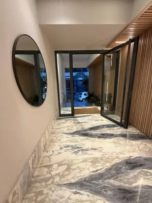 a mirror on the side of a room with a tile floor at Ideal home away from home in Maarif