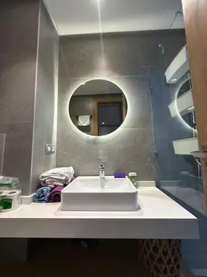 a bathroom with a white sink and a mirror at Ideal home away from home in Maarif