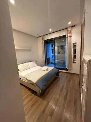 a bedroom with a bed and a large window at Ideal home away from home in Maarif