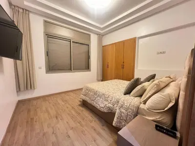 a bedroom with a bed and a flat screen tv at Sweet appartement Boulevard de Paris à 2min du centre ville in Casablanca