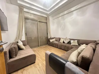 a living room with two brown couches and a ceiling at Sweet appartement Boulevard de Paris à 2min du centre ville in Casablanca