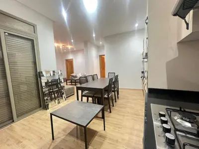 a kitchen and dining room with a table and chairs at Sweet appartement Boulevard de Paris à 2min du centre ville in Casablanca