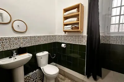 a bathroom with a toilet and a sink and a mirror at Ary déco flat in Casablanca city center in Casablanca