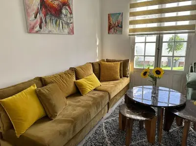 a living room with a couch and a table at Ary déco flat in Casablanca city center in Casablanca