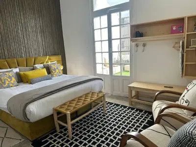 a bedroom with a large bed and a window at Ary déco flat in Casablanca city center in Casablanca