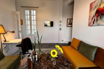 a living room with a couch and a table at Ary déco flat in Casablanca city center in Casablanca