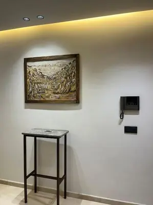 a table in a room with a painting on a wall at Modern minimaliste retreat in Maarif in Casablanca
