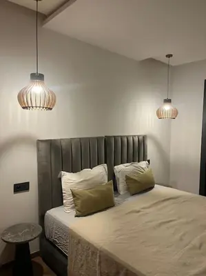 a bedroom with a bed with two pillows and two lights at Modern minimaliste retreat in Maarif in Casablanca