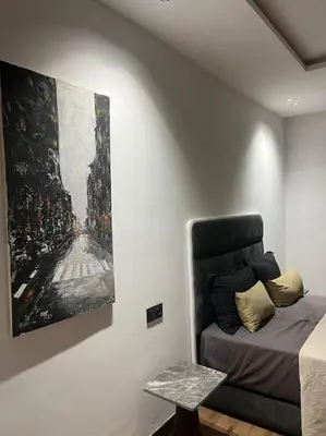 a bedroom with a painting on the wall next to a bed at Modern minimaliste retreat in Maarif in Casablanca