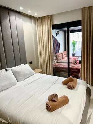 a bedroom with a bed with towels on it at Luxury apartment in Casablanca