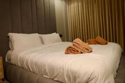 a bed with two towels on top of it at Luxury apartment in Casablanca