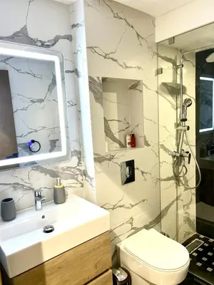 a bathroom with a sink and a shower and a toilet at Luxury apartment in Casablanca