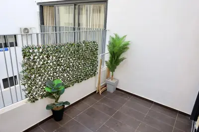 a balcony with a green hedge with a plant at Luxury apartment in Casablanca