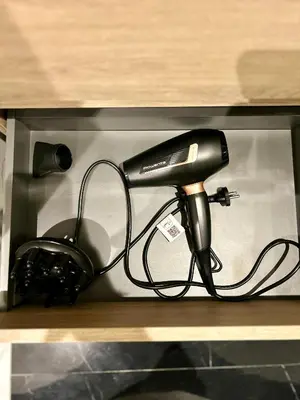 a black blow dryer sitting on a shelf at Luxury apartment in Casablanca