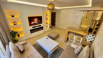 a living room with a couch and a table at N8 appartement, 3 Chambres Haut de Gamme, a Deux Pas de l Ocean et du Mall in Rabat