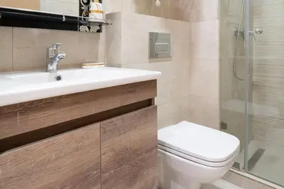 a bathroom with a toilet and a sink and a shower at Chic 2 chambres balcon vue panoramique et piscine in Aïn Harrouda
