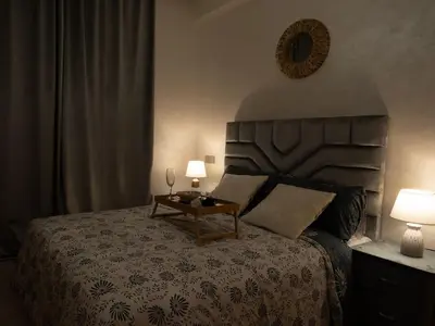 a bedroom with a bed with two lamps and a table at Magnifique 2 chambres, vue panoramique et piscine in Casablanca