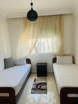 two beds in a room with a window at Lovely 2 bedrooms Furnished Bourgogne in Casablanca