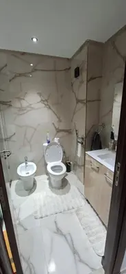 a bathroom with a toilet and a sink at Residence la corniche d in Mohammedia