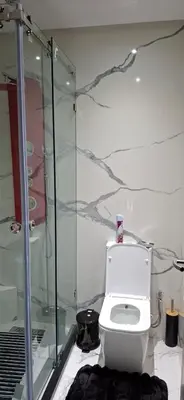 a bathroom with a toilet and a glass shower at Residence la corniche d in Mohammedia