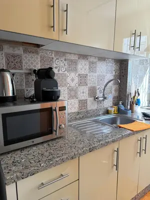 a kitchen counter with a microwave and a sink at Apartement agdal in Rabat