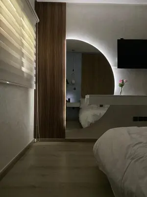 a bedroom with a bed and a large mirror at Apartement agdal in Rabat