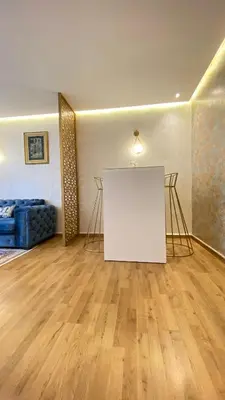a living room with a white table in a room at Apartement agdal in Rabat