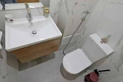 a bathroom with a white sink and a toilet at 3BD Appart à 2 min Gare Agdal Luxe & Confort in Rabat