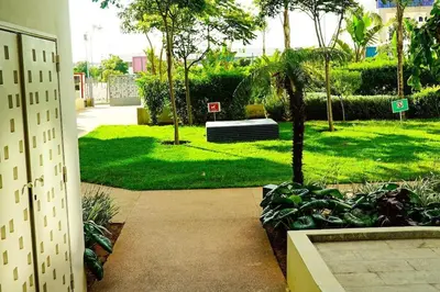 a park with a bench sitting in the grass at 3BD Appart à 2 min Gare Agdal Luxe & Confort in Rabat