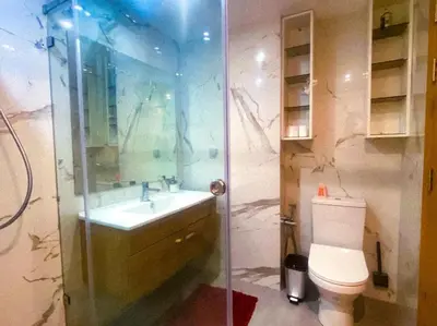 a bathroom with a toilet and a sink and a shower at 3BD Appart à 2 min Gare Agdal Luxe & Confort in Rabat