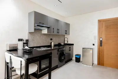 a kitchen with a stove and a counter top at Appartement cosy et moderne Bouskoura proche Aéroport et Hopital universitaire in Bouskoura
