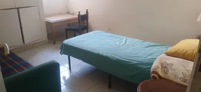 a bedroom with a bed and a desk and a chair at best location single room in Casablanca