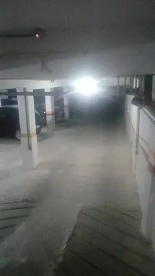 a parking garage with a light on the ceiling at best location single room in Casablanca