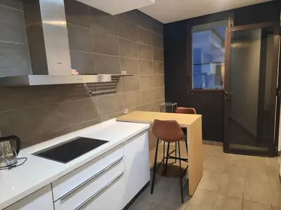 a kitchen with a counter and a table and a stool at Blue Anfa Place in Casablanca