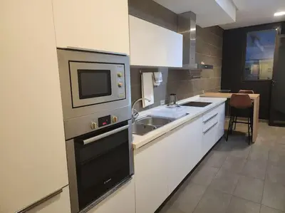 a kitchen with a sink and a microwave at Blue Anfa Place in Casablanca