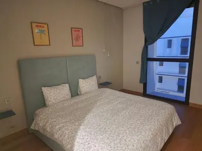 a bedroom with a large bed and a window at Blue Anfa Place in Casablanca