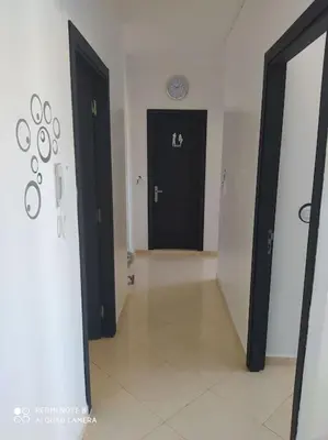 a hallway with two black doors in a room at Appartement neuf tres calme balcon vue sur l'océan in Skhirat