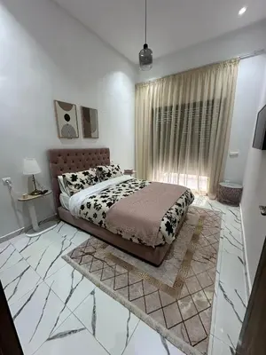 a bedroom with a large bed and a window at Magnificent Cozy New Luxury Condo in Prime Casablanca Location in Les Camps
