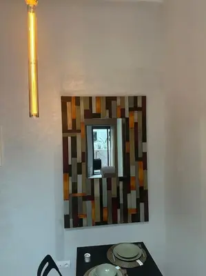 a mirror on a wall in a room at Magnificent Cozy New Luxury Condo in Prime Casablanca Location in Les Camps